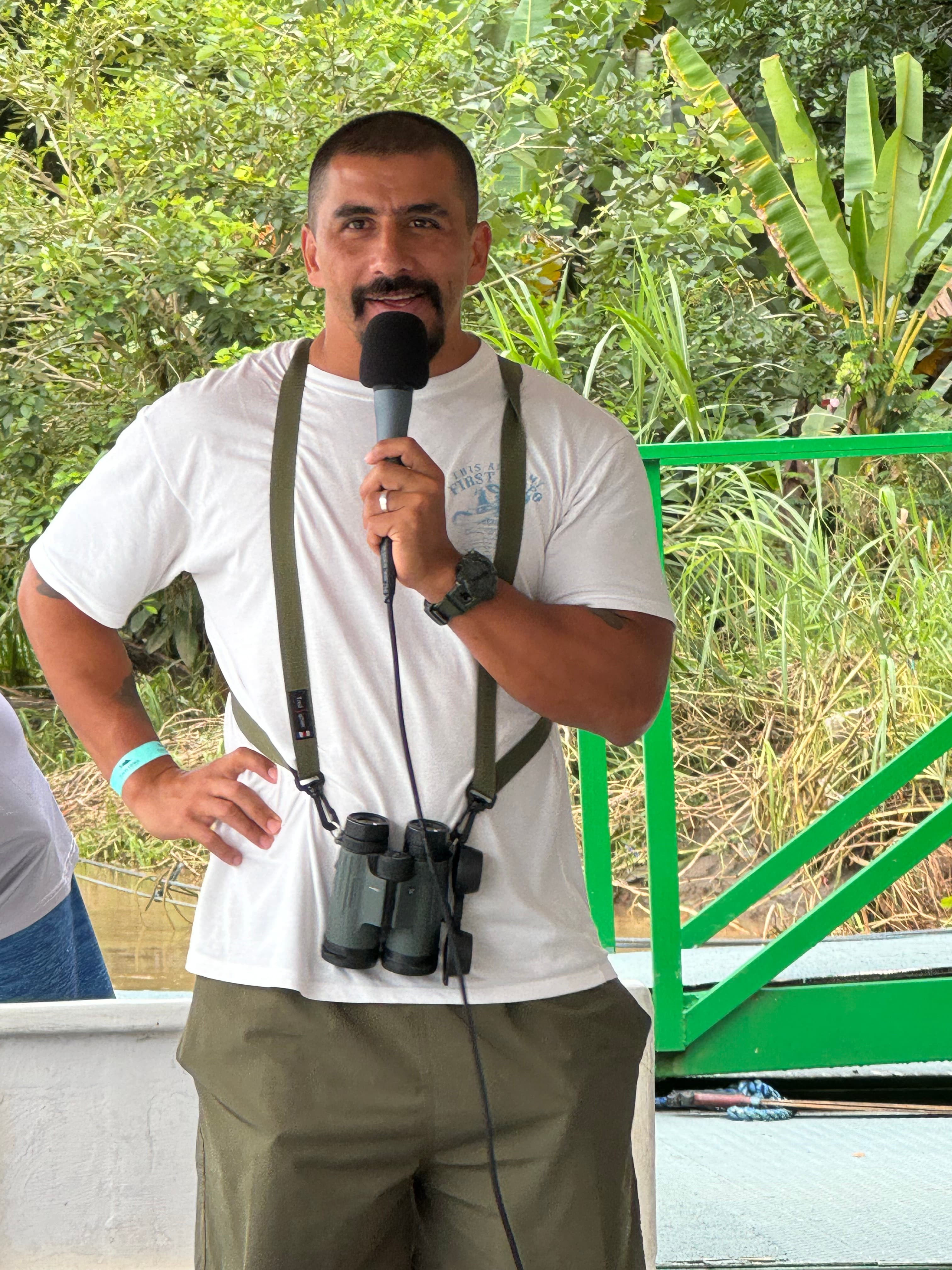 Erick Miranda standing outdoors in his guide uniform, smiling at the camera